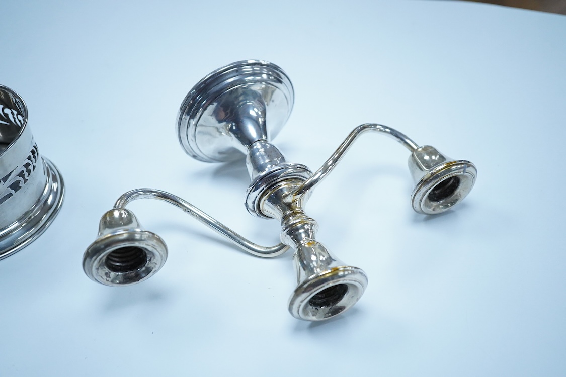 A North America sterling two branch, three branch candelabrum, by Frank M. Whiting & Co, height 15.4cm, weighted, together with a pierced 900 standard white metal bottle coaster, 5.4oz.